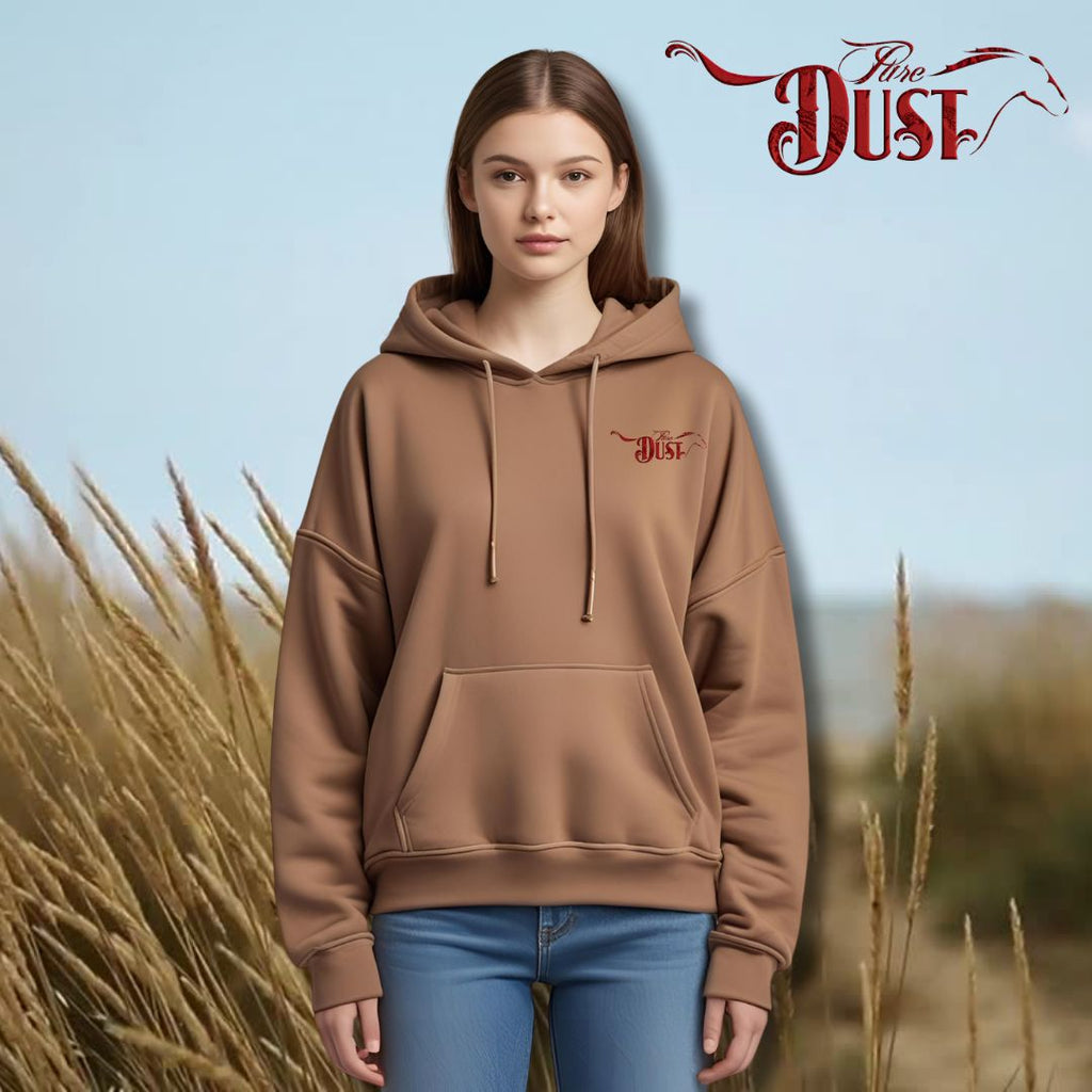 Person wearing a brown hoodie with 'Dust' logo against a natural background
