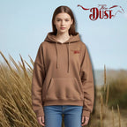 Person wearing a brown hoodie with 'Dust' logo against a natural background