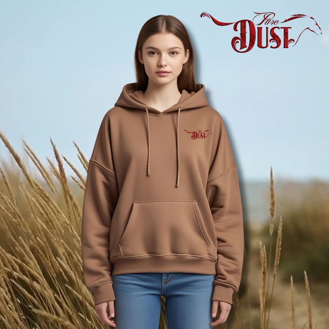 Person wearing a brown hoodie with 'Dust' logo against a natural background